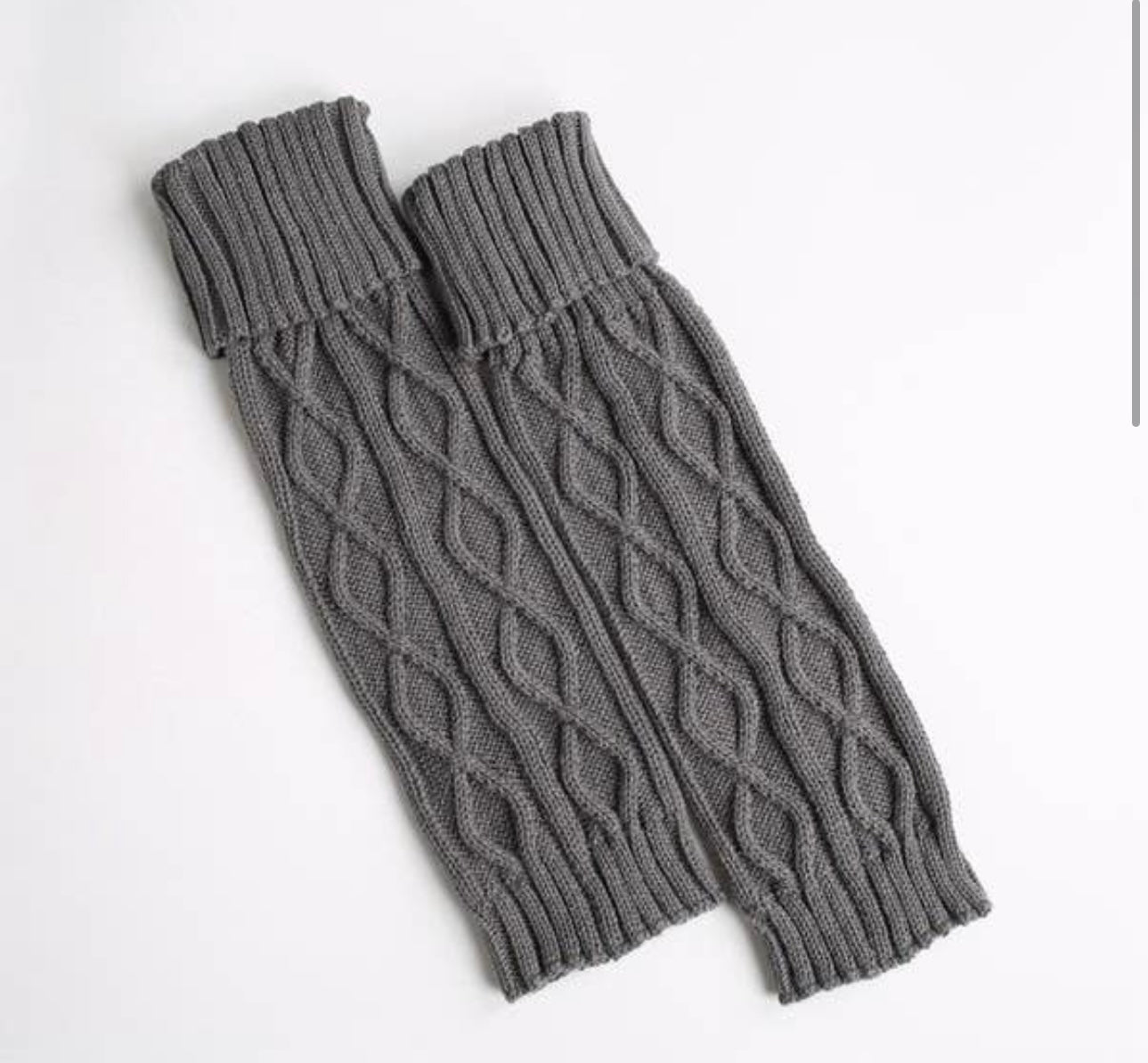 Introducing our Sweater Leg Warmers! Made with twisted knit, these Dandy Leg Warmers offer both warmth and style. Cozy up in your favorite leggings, uggs, and sweater combo with these grey leg warmers. Perfect for chilly days and fashionable outings.