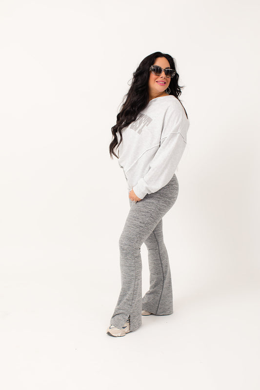 Perfect for all-day wear, our Charcoal Slit Flare Leggings are made with luxurious brushed melange material for ultimate comfort. The eye-catching flared silhouette includes ankle slits and a hidden pack pocket in the waistband for convenient storage while on the go. Comfort and style in one package!