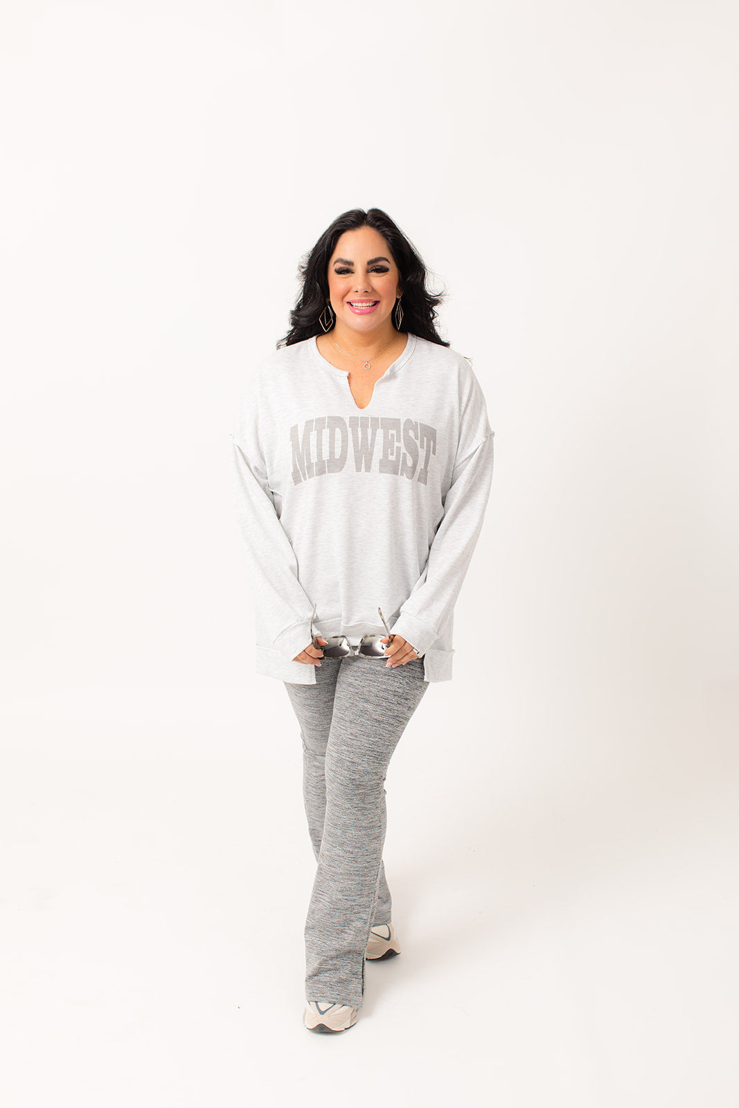 This light grey sweatshirt features an oversized, loose fit for maximum comfort and a contrast stitch design for added style. The notch neck adds a unique touch, while the Western graphic adds a touch of personality. Stay cozy and fashionable with the Midwest Graphic Light Sweater.