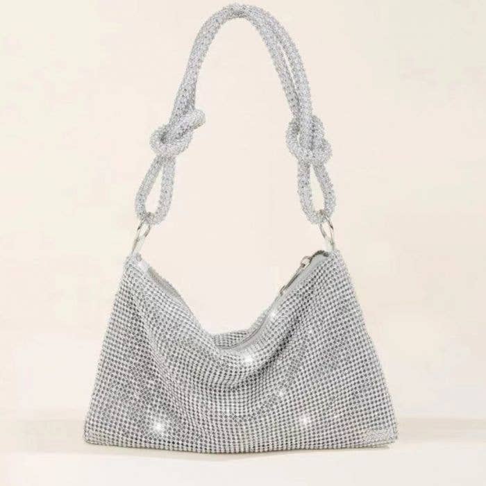 Expertly crafted with dazzling crystals, the Bling Slouch Bag effortlessly combines the timeless elegance of a clutch with the modern appeal of a slouch bag. Elevate any outfit with this statement piece that exudes sophistication and subtle glamour.