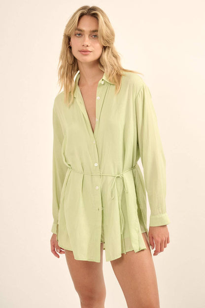 Introducing the Mellow Green Romper - your new go-to for effortless style. This satin piece features a layered design, button-front closure, and removable tie belt for a customizable fit. With a dress shirt overlayer and shorts lining, this romper offers a relaxed fit and side slits for added comfort. Elevate your wardrobe with this thigh-length, high-waisted gem.